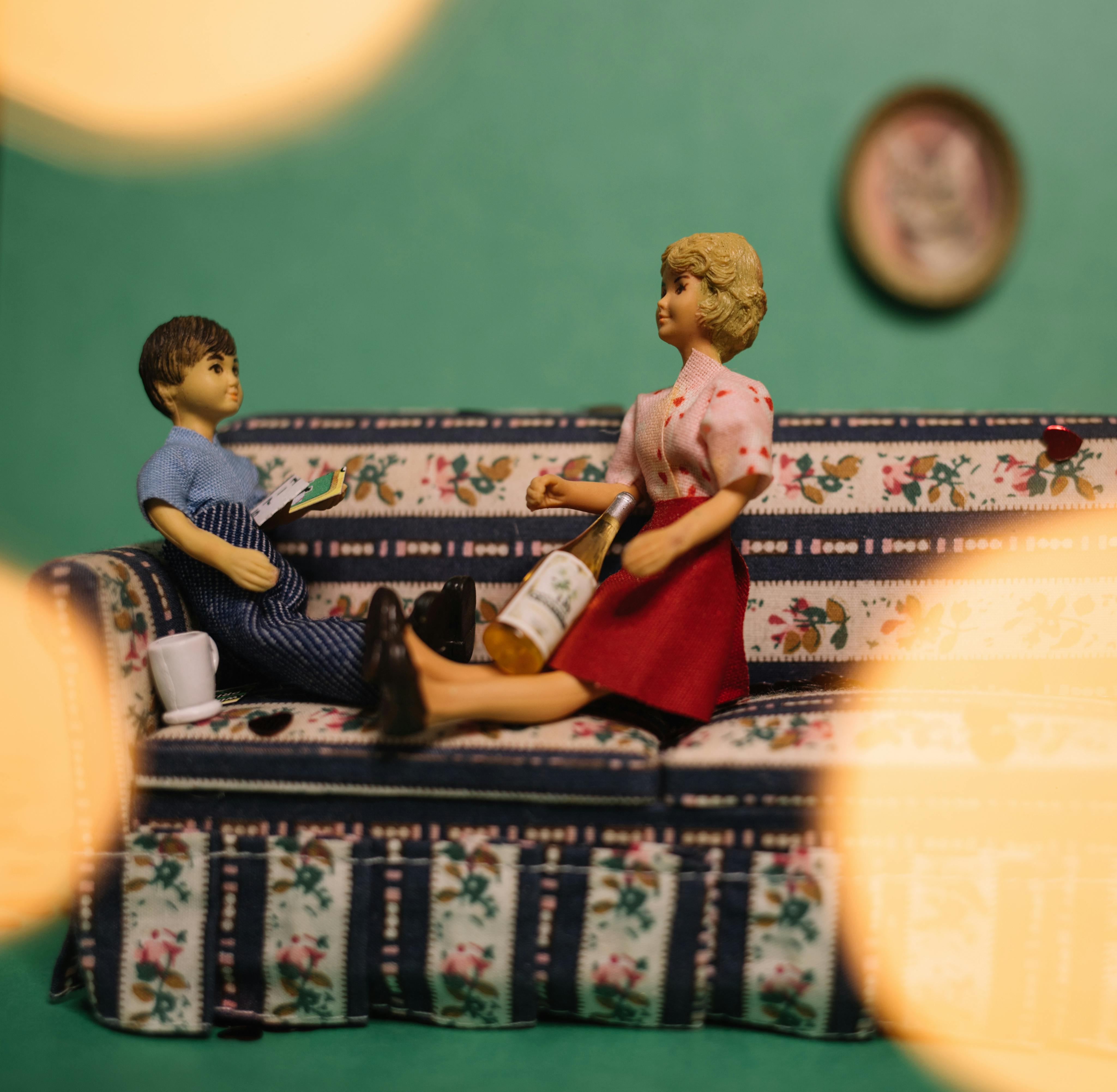 Charming scene with toy figures on a colorful mini sofa.