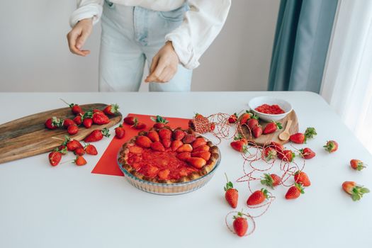 Delightful strawberry pie with fresh fruits on a table. A perfect dessert presentation.