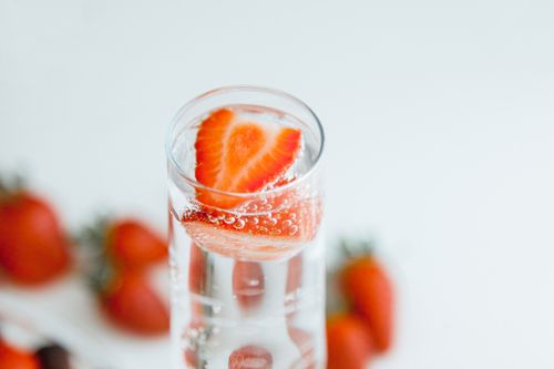 Free Close-up of strawberries in sparkling water, emphasizing freshness and hydration. Stock Photo