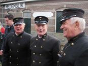 Three elderly men in vintage railway uniforms at Medemblik station, Netherlands.