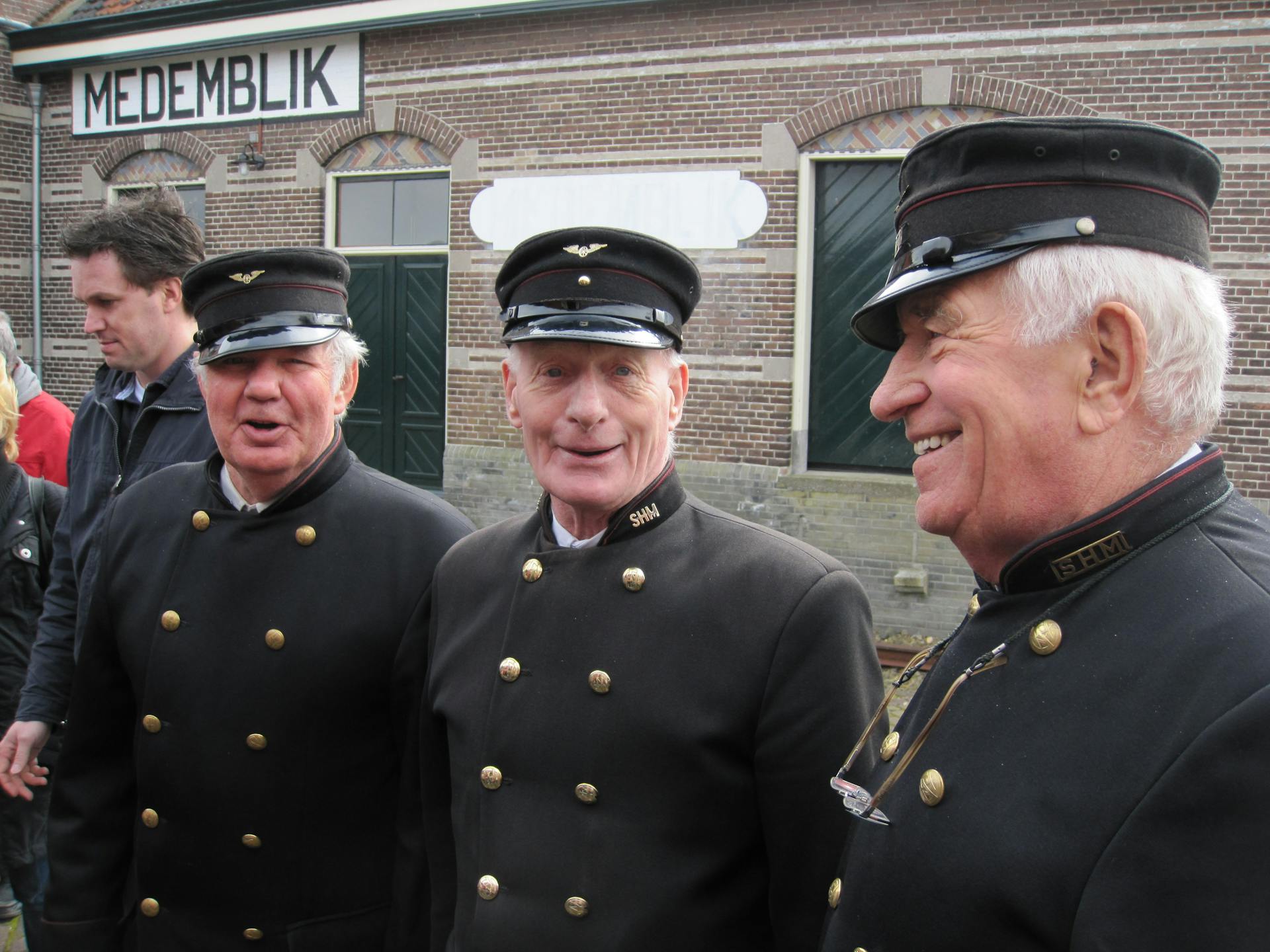 Group of Senior Men in Black Railway Uniforms