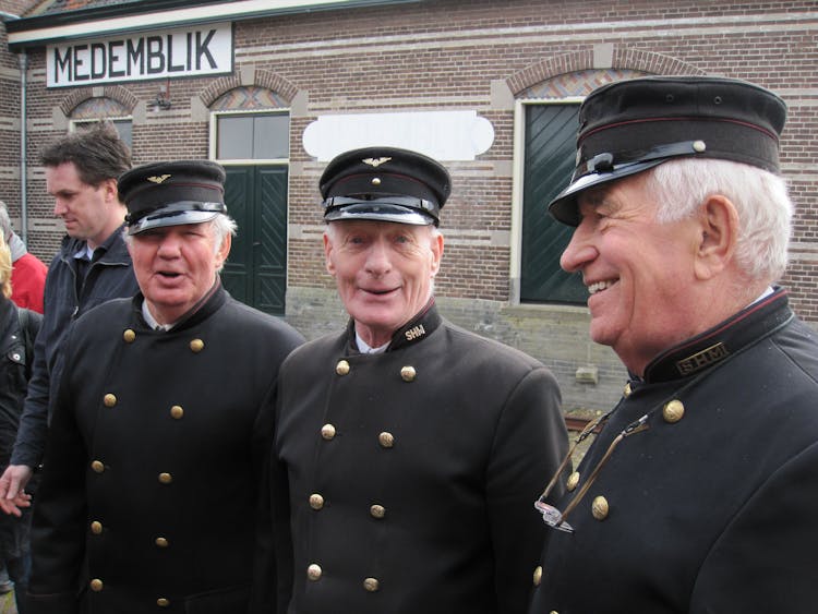 Group Of Senior Men In Black Railway Uniforms