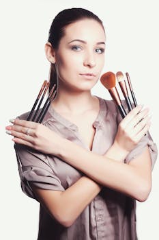 Portrait of a woman holding makeup brushes showcasing elegance and beauty.