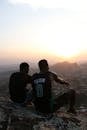 2 Men Sitting on Rock