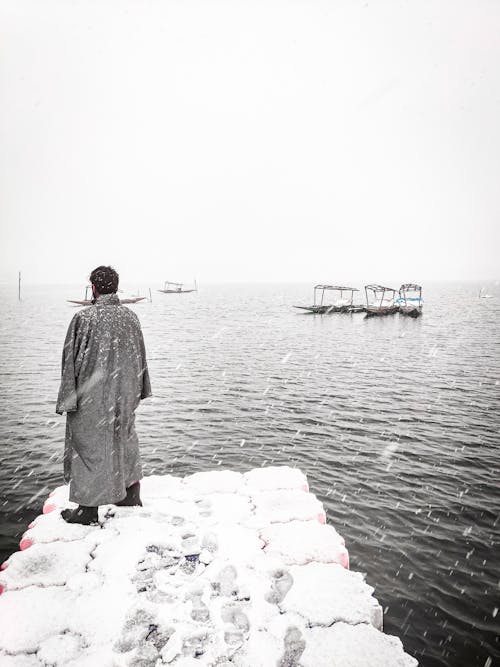 Man Standing on Pier on Winter Day