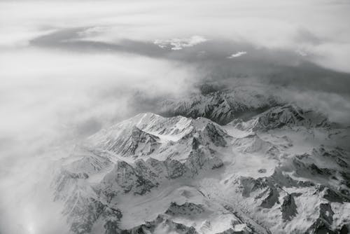 Snow Covered Mountain Under Cloudy Sky