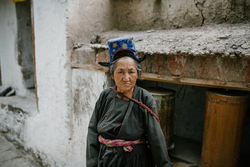 Elderly Woman in Traditional Clothing Seriously Looking at the Camera