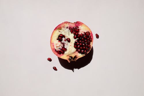 Free Sliced Pomegranate on White Surface Stock Photo