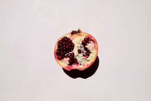Halved Pomegranate on a White Surface