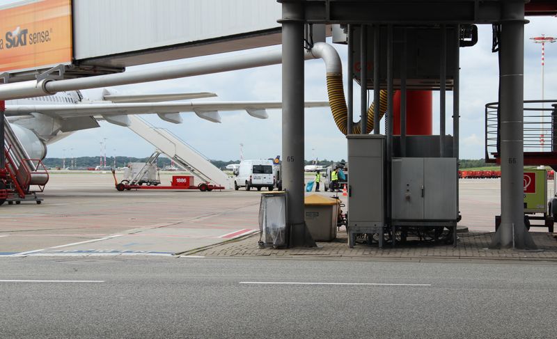 Aircraft preparation on the tarmac with ground maintenance equipment