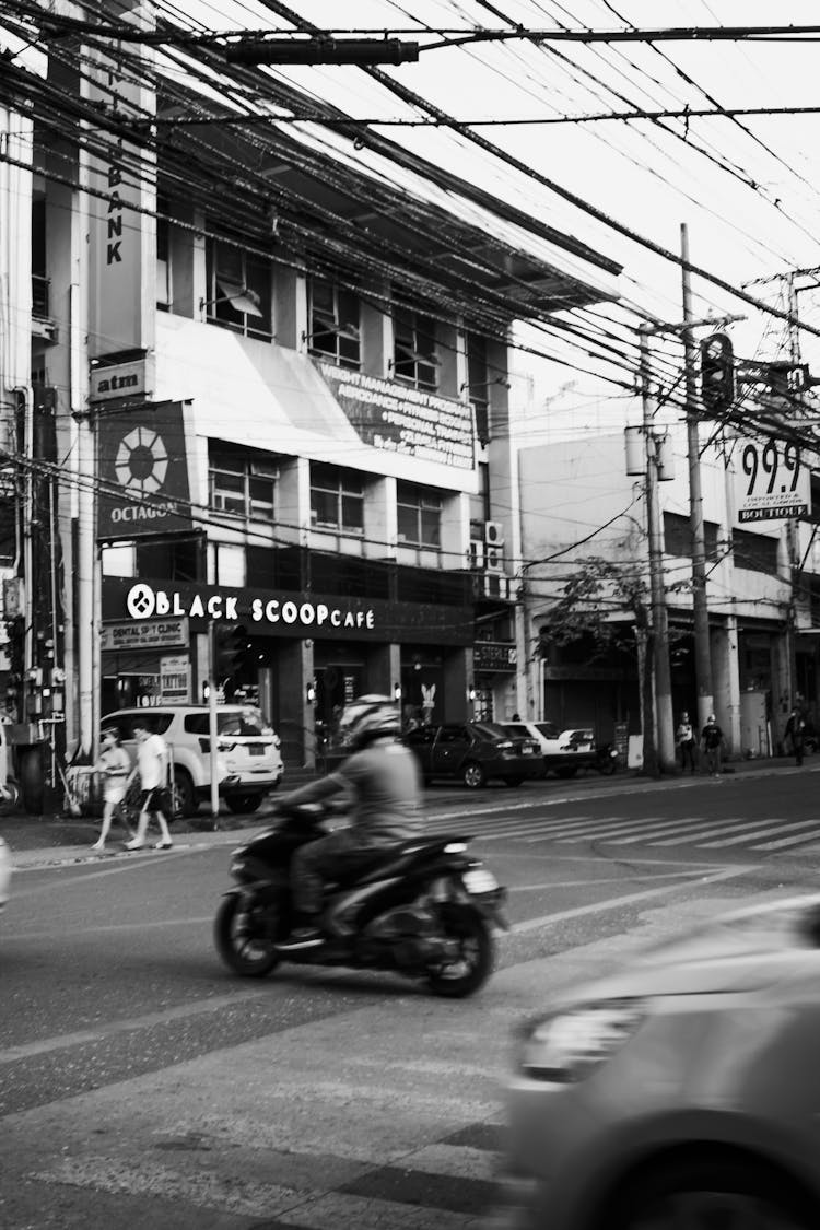 Motorcyclist Riding On Modern City Crossroads