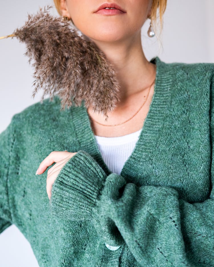 Woman With Reed In Green Woolen Cardigan