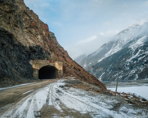 Free Winter landscape with a rustic tunnel in a snow-covered mountainous region. Stock Photo
