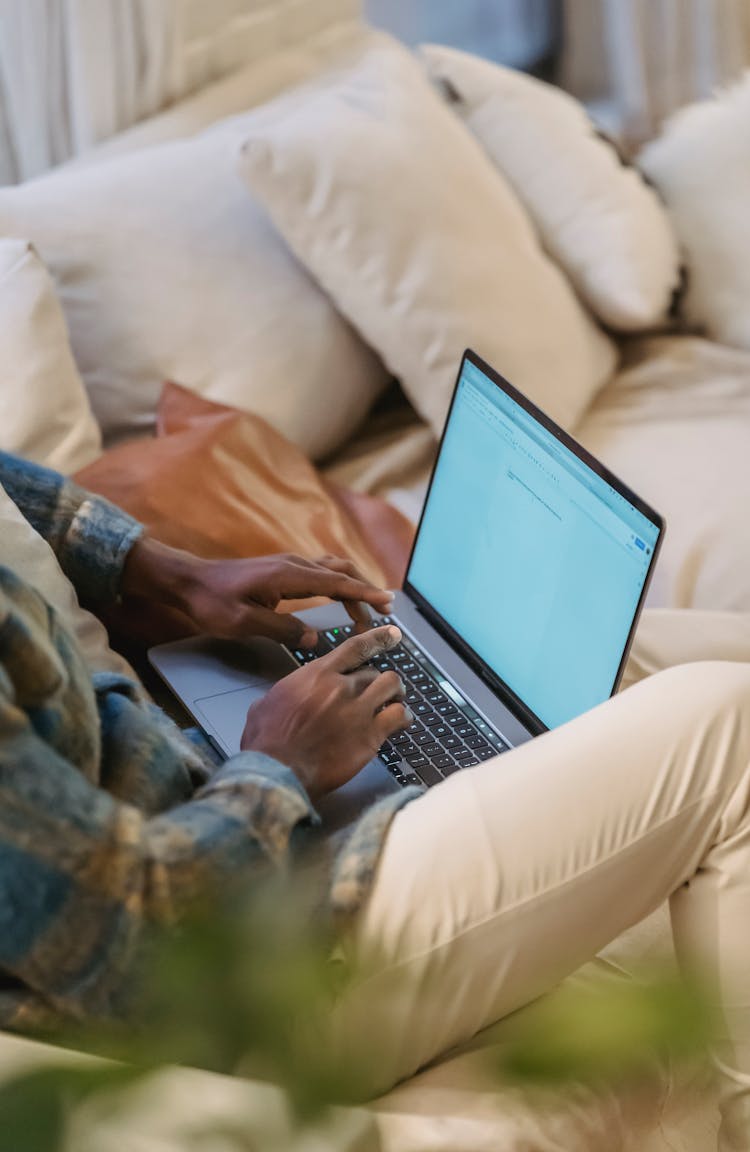 African American Man Typing On Laptop Keyboard