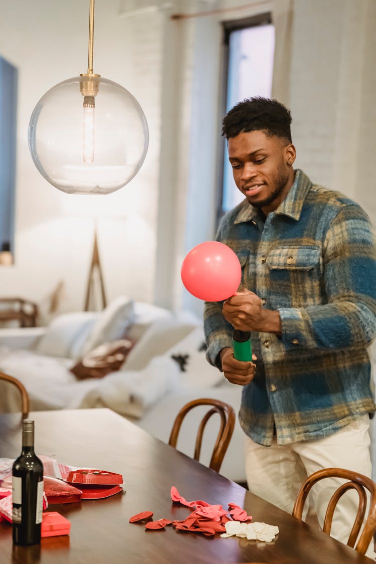 Busy Black Guy Inflate Balloon With Pump