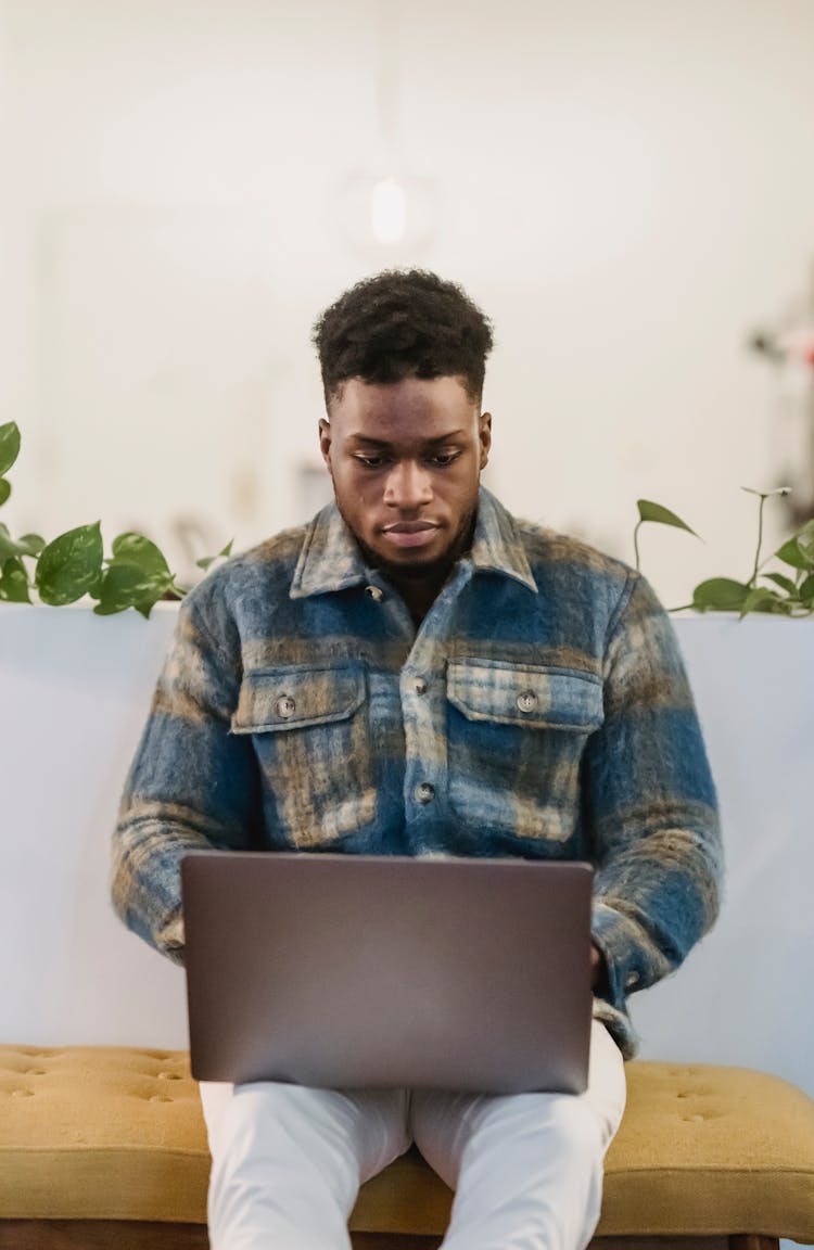 Focused Self Employed Black Guy Working Online On Netbook