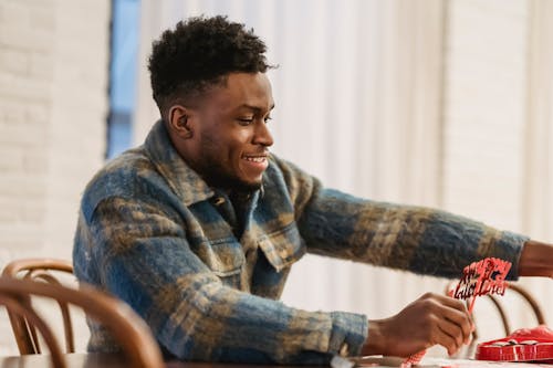 Focused black man with valentine accessories