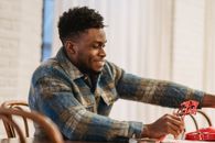 Focused black man with valentine accessories