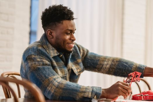 Focused black man with valentine accessories