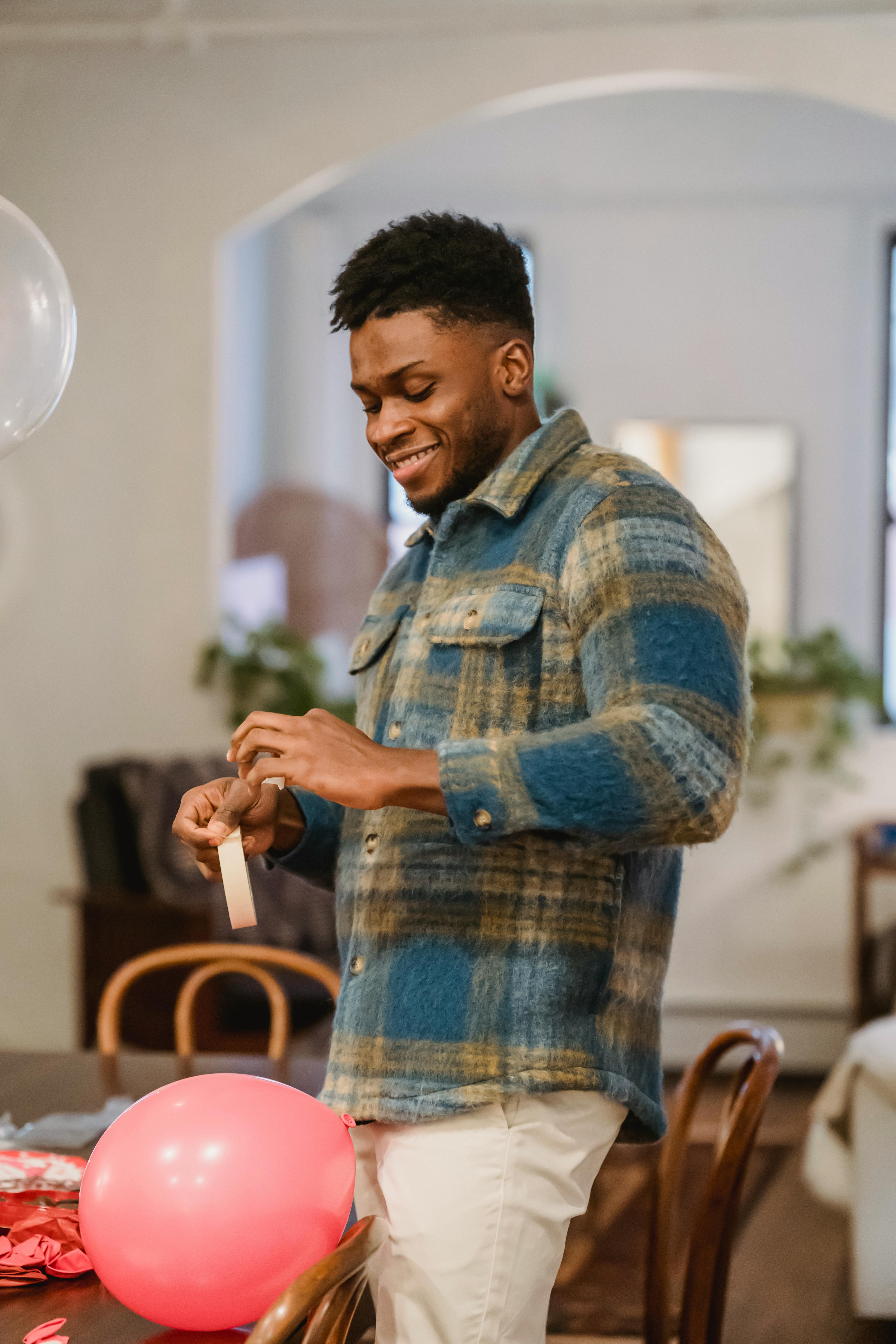 glad black guy with scotch tape decorating apartment