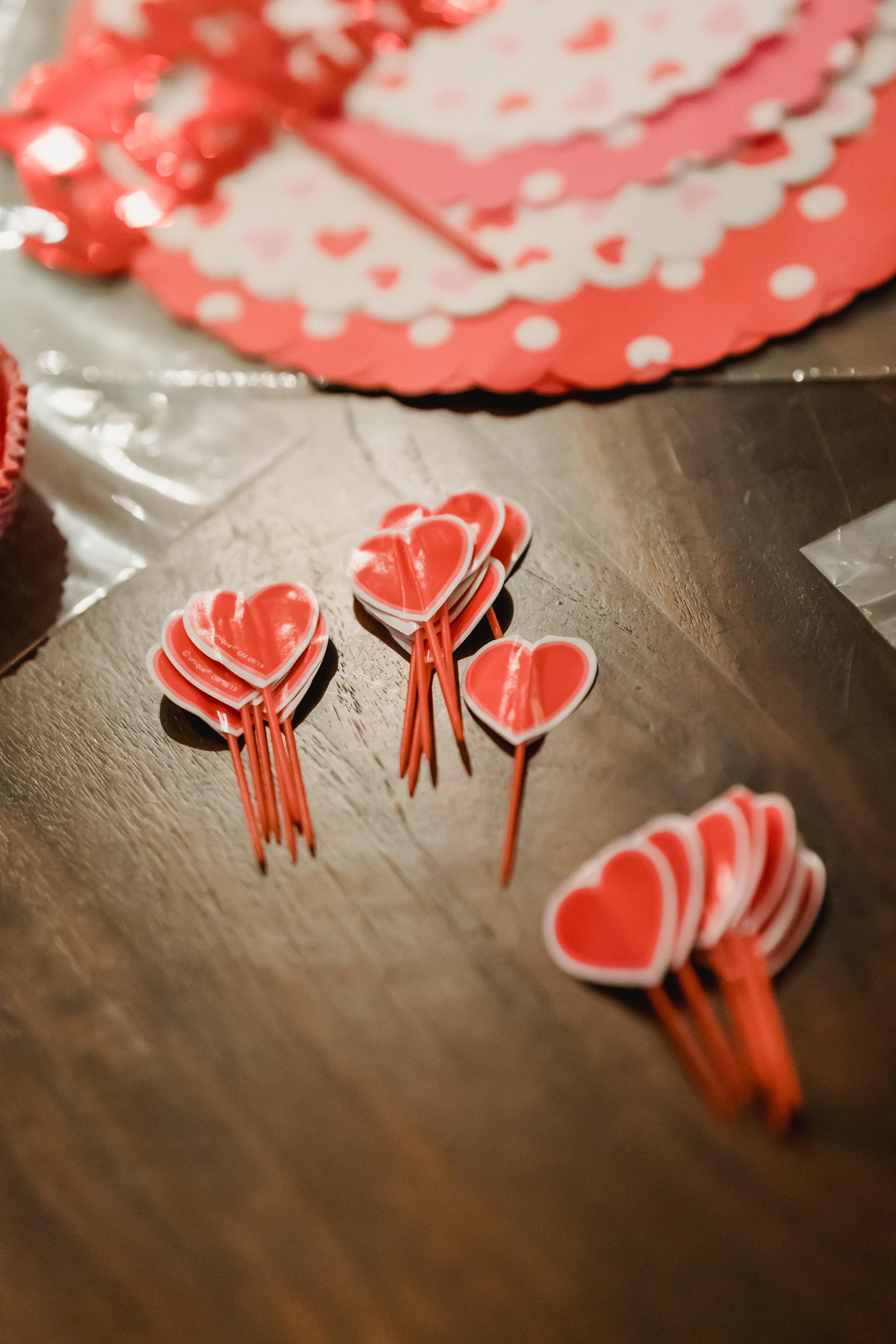 red heart decorations on wooden table