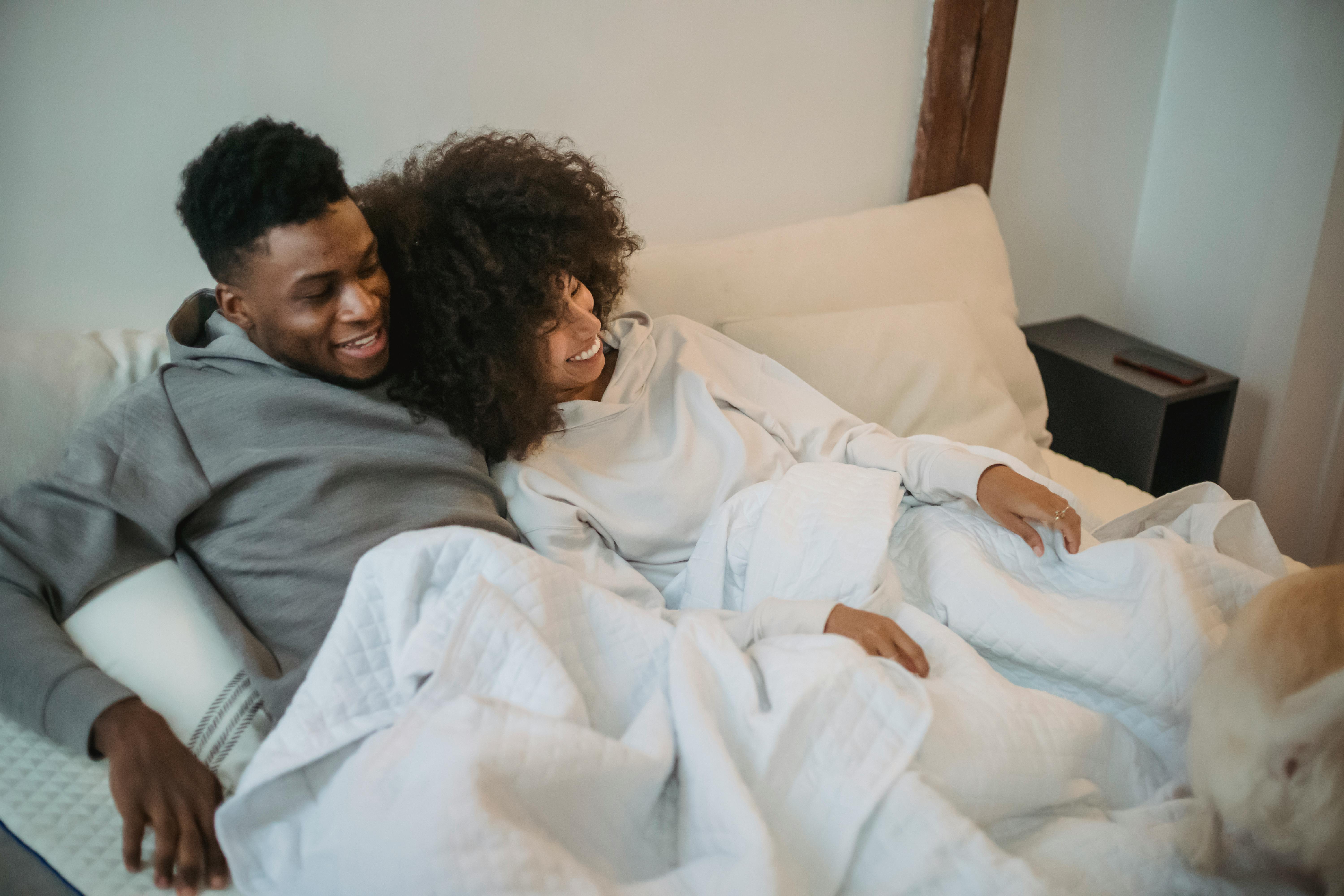 Free Loving black couple with dog on bed Stock Photo