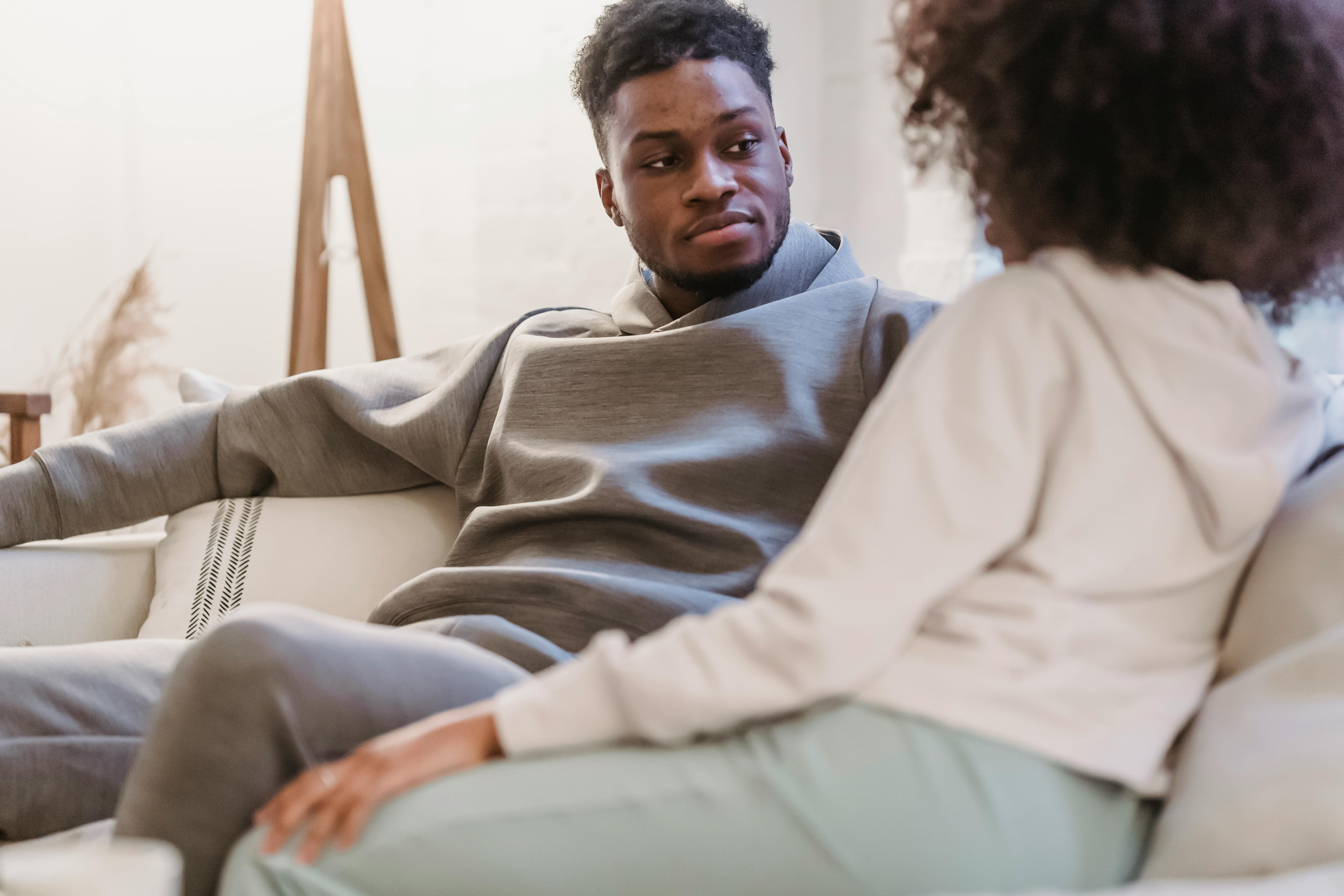 black couple in casual clothes resting and talking