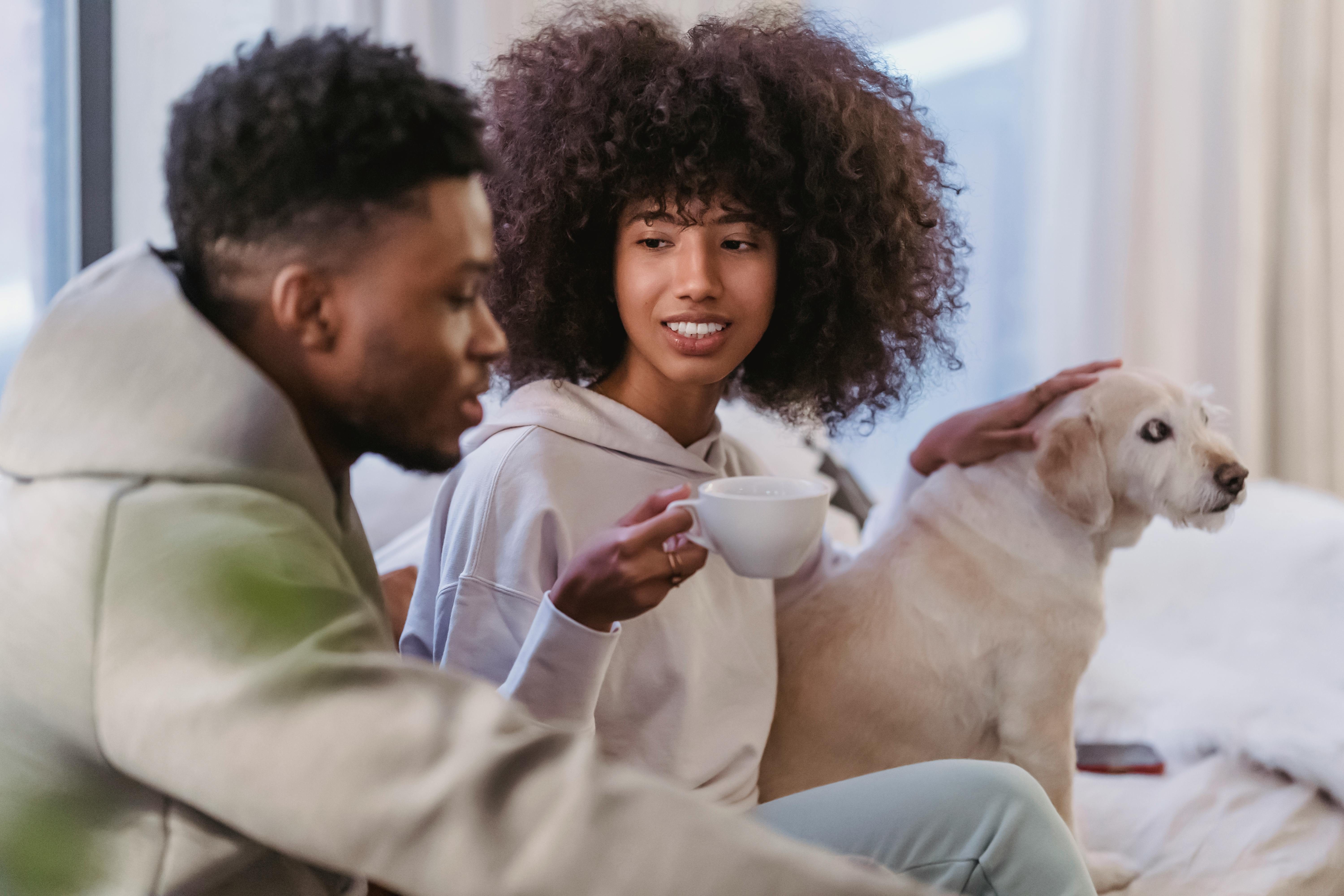 black boyfriend talking with girlfriend stroking dog