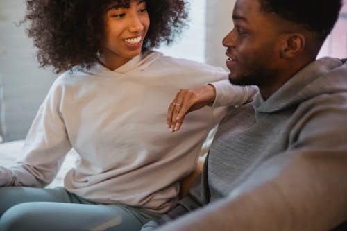 Happy black couple communicating in room