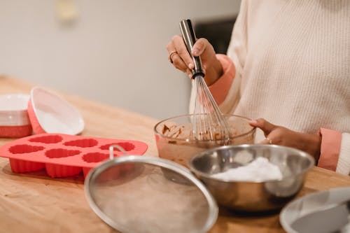 Free Crop woman mixing batter in kitchen Stock Photo
