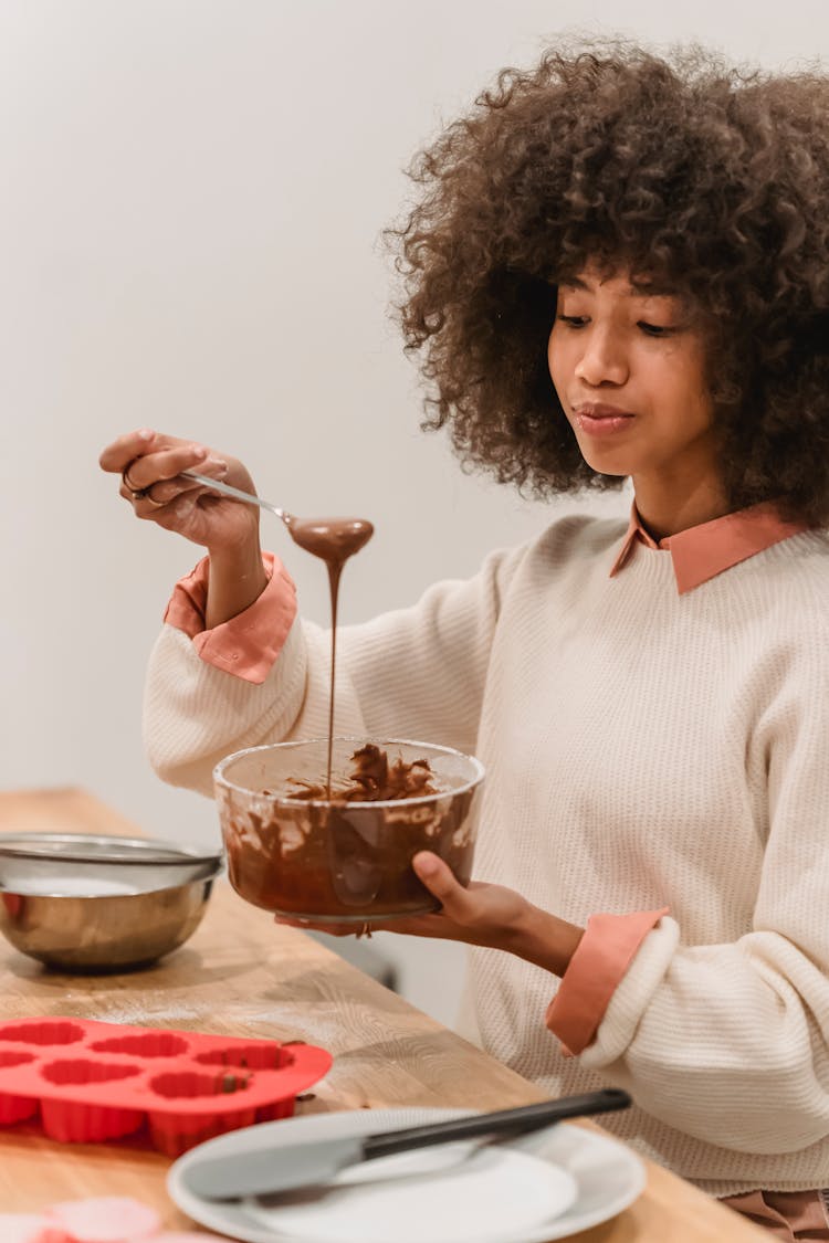 Black Woman Mixing Melted Chocolate In Bowl For Cooking