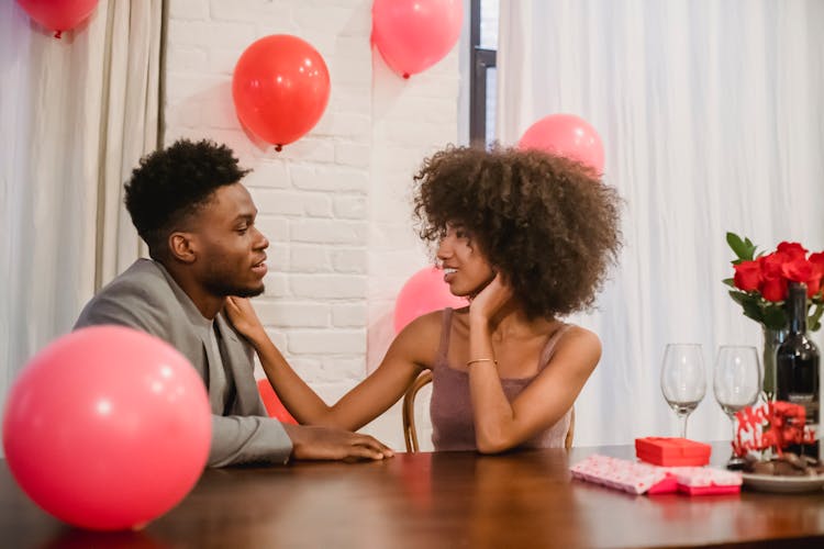 African American Couple Having Date At Table With Presents