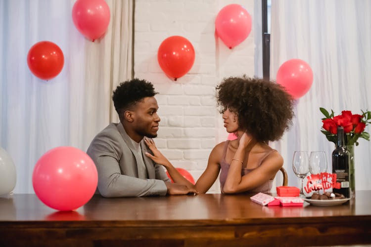 Black Couple Celebrating Holiday While Having Conversation At Table