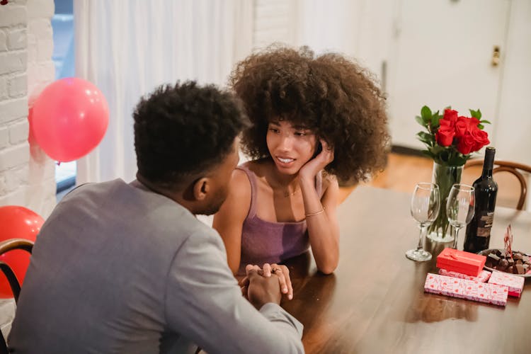 African American Couple Talking While Having Date At Table