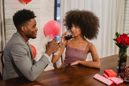 Free African American couple drinking wine while having date at table Stock Photo