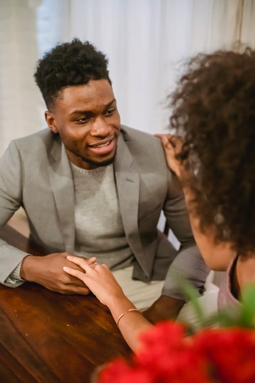 Free Black couple having date at table while having conversation Stock Photo