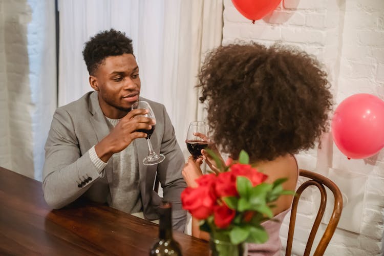 African American Couple Having Date While Drinking Wine At Table