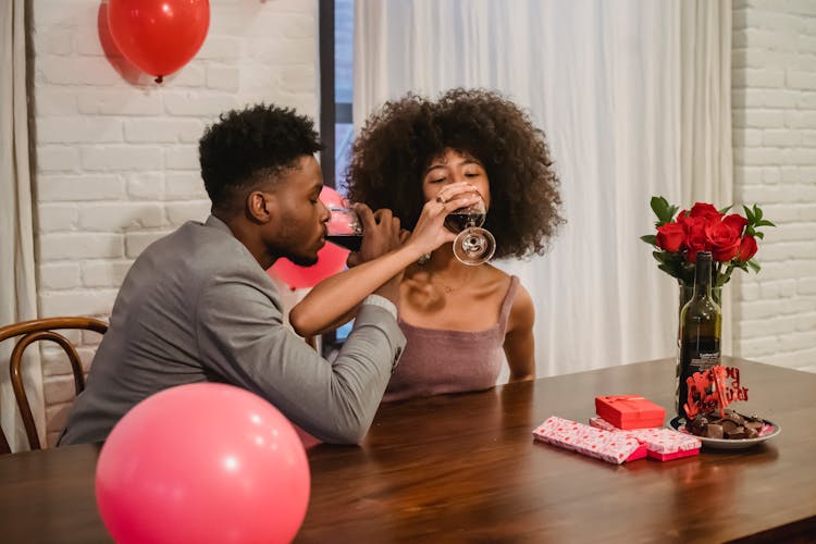 African American Couple Drinking Wine At Table