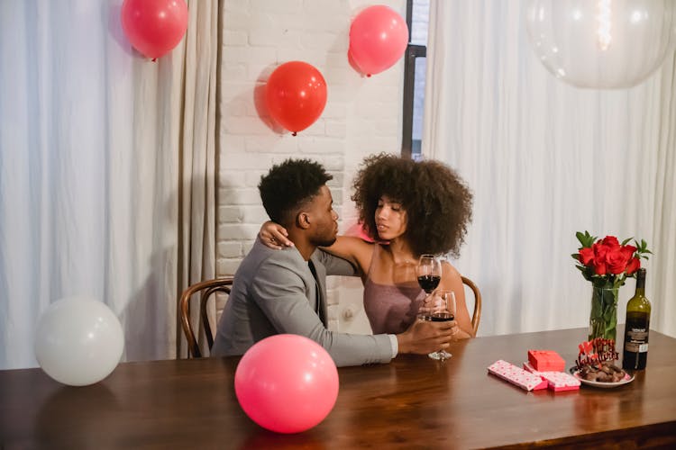 Young African American Couple Drinking Wine During Celebration