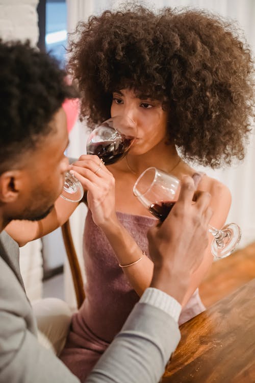 Happy couple drinking wine during date
