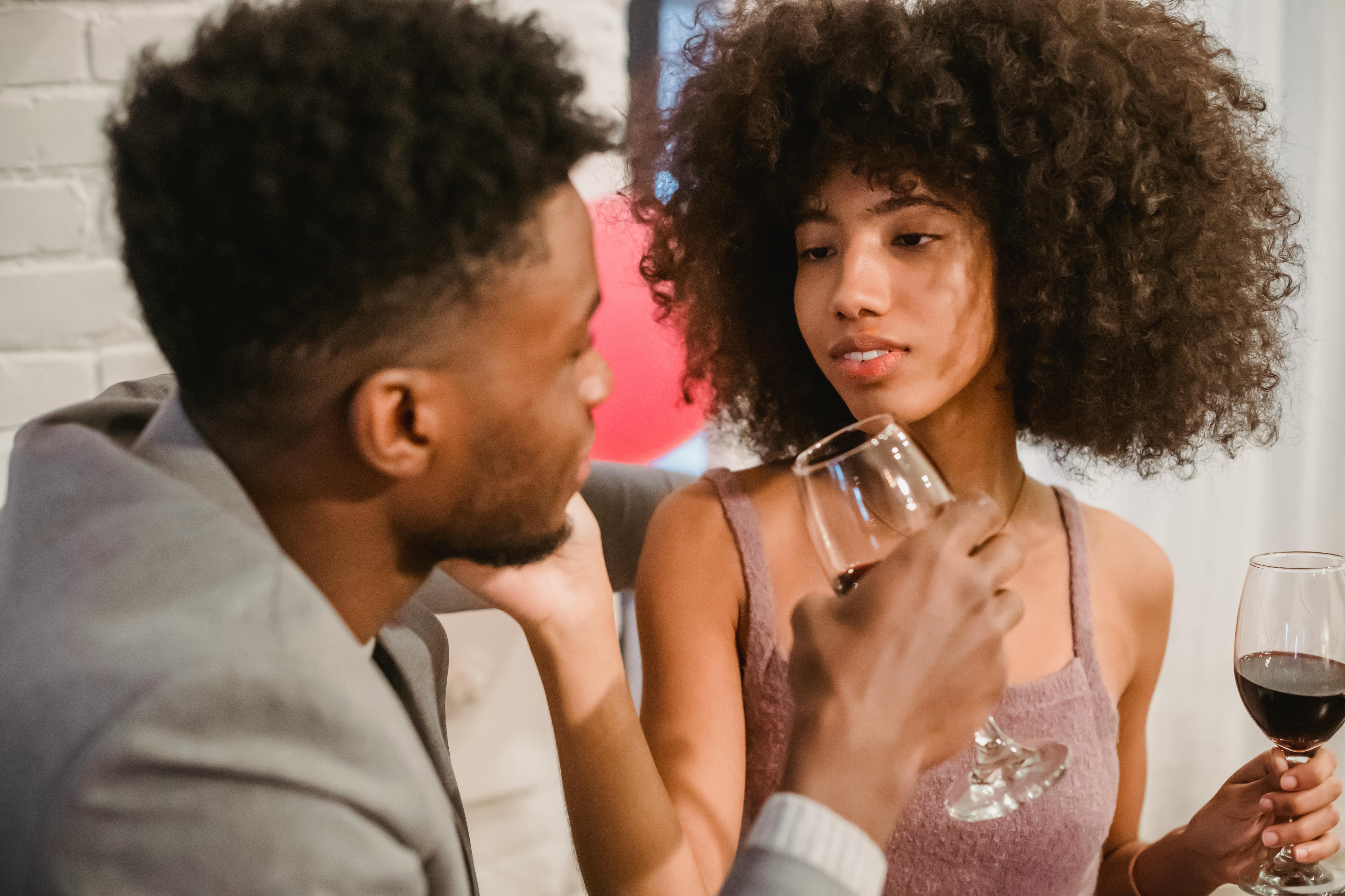 happy black woman drinking wine with boyfriend