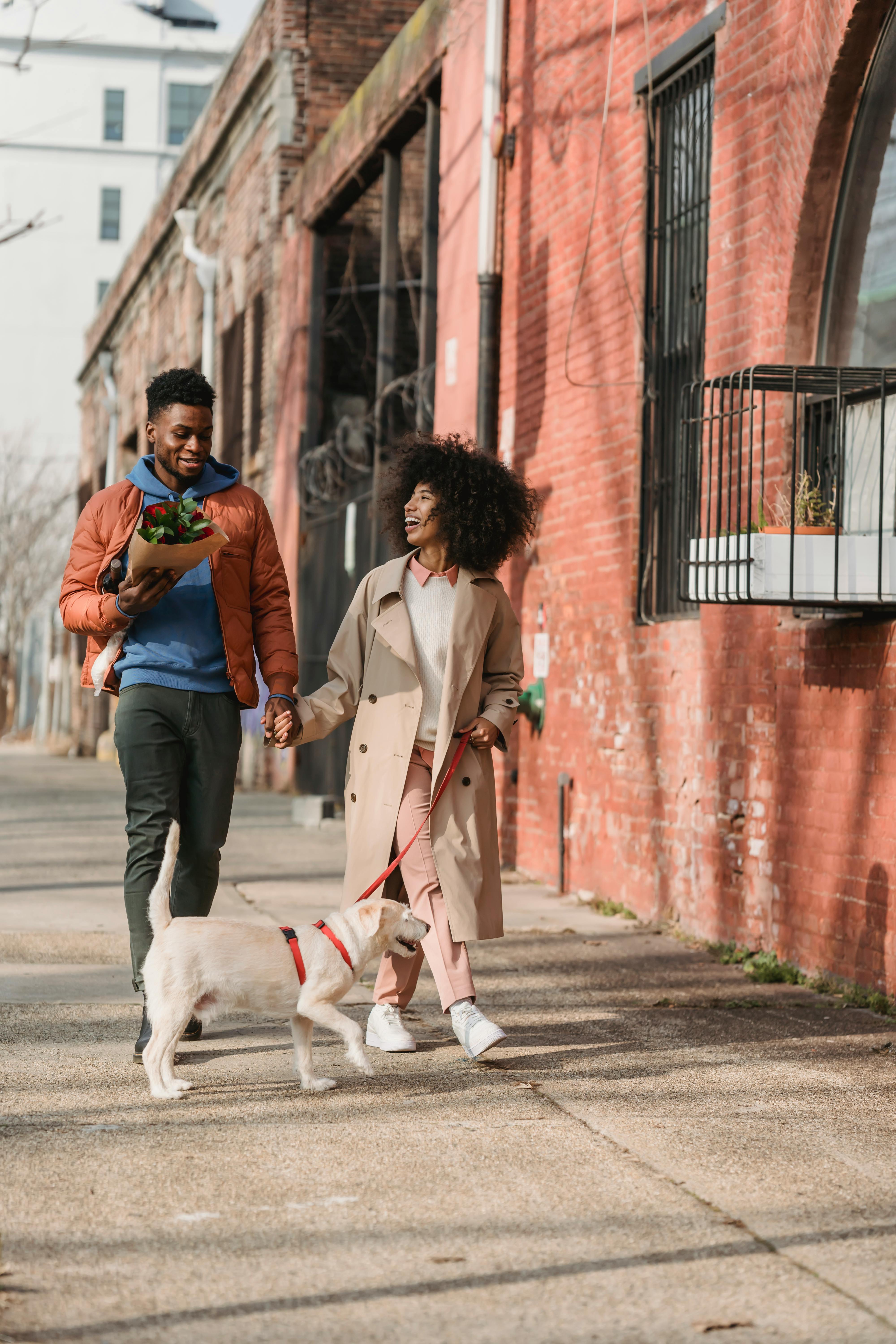 romantic black couple walking with dog