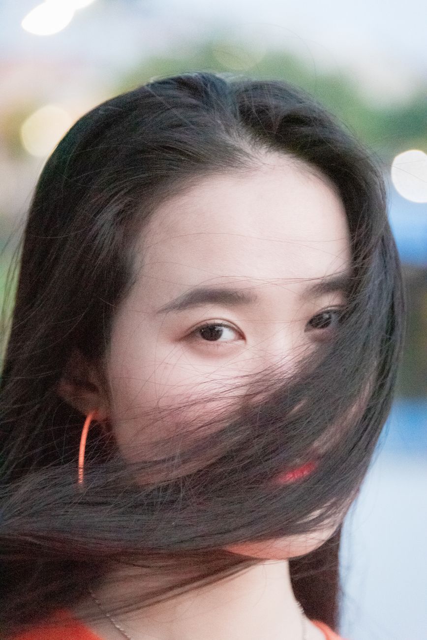 Captivating portrait of a young woman with flowing hair in vibrant Ho Chi Minh City.