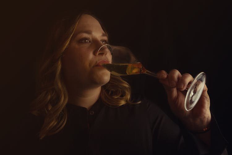 Woman Drinking Fine White Wine In Darkness