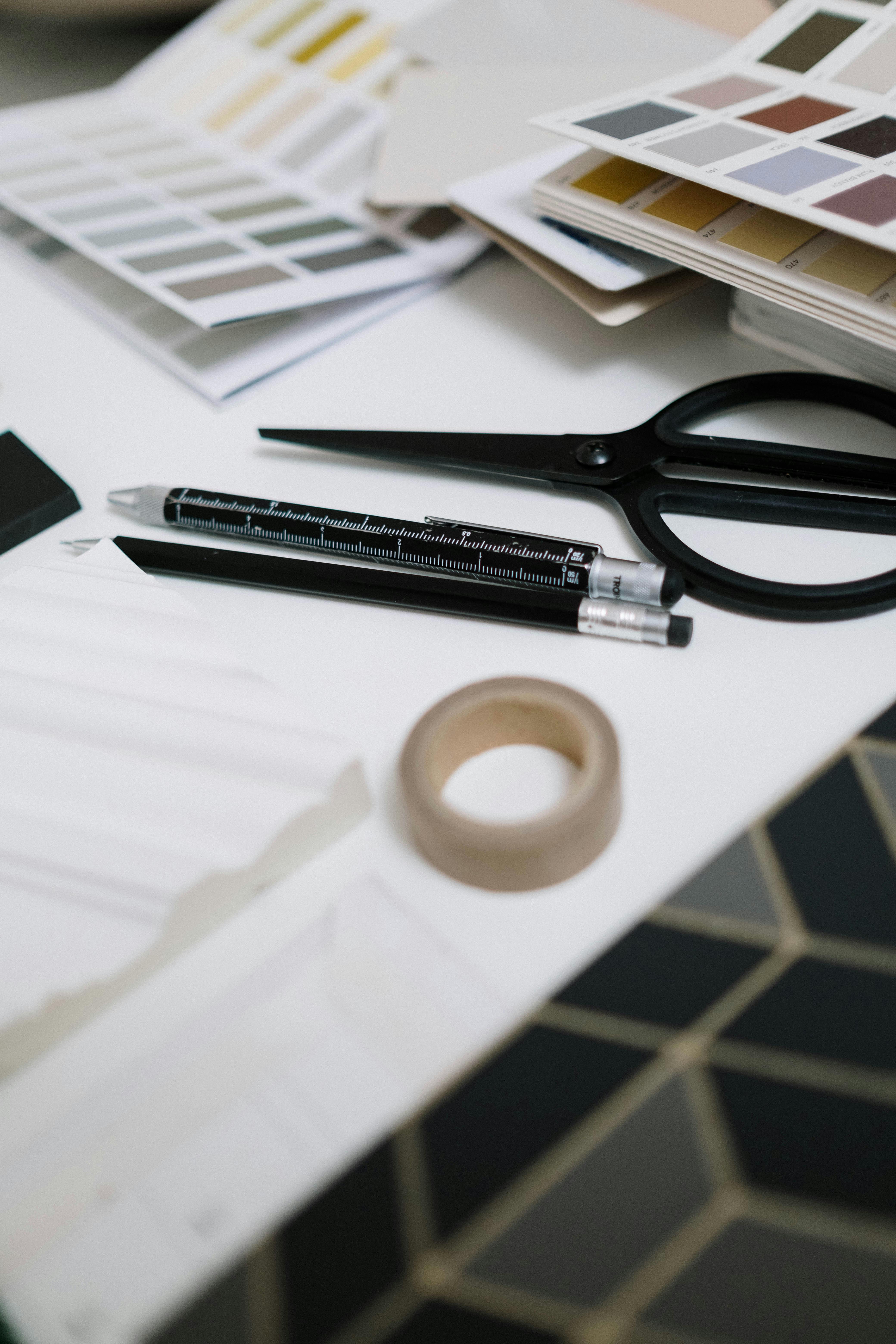 scissors and pens on a white surface