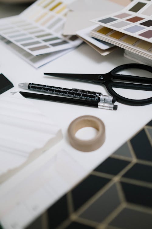 Scissors and Pens on a White Surface