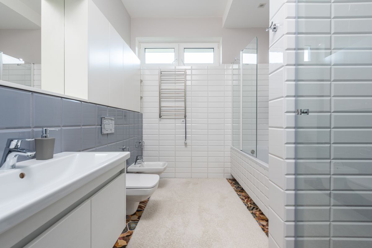 small wet room with toilet floating vanity and skylight