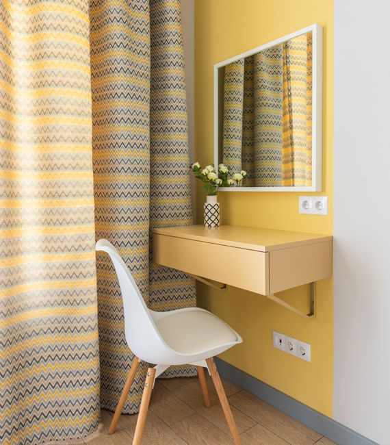 Modern design of wooden wall table with pull out drawer under big mirror and comfortable white chair