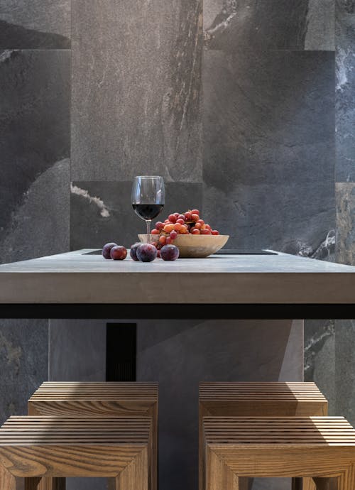 Table with Glass of Wine and Bowl of Grapes Near the Wall
