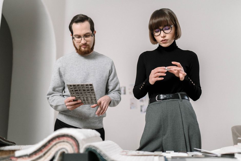 Creative designers analyzing brand guidelines and visual assets Creative designers analyzing brand guidelines and visual assets
